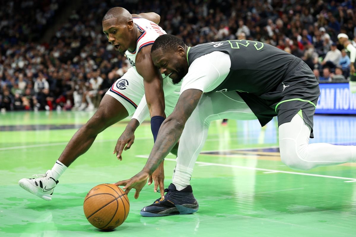 Nov 29, 2024; Minneapolis, Minnesota, USA; Minnesota Timberwolves forward Julius Randle (30) and LA Clippers guard Kris Dunn (8) compete for the ball during the second quarter of an NBA Cup game at Target Center. Mandatory Credit: Matt Krohn-Imagn Images