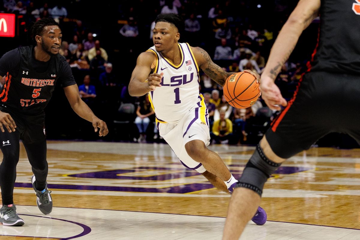 Nov 29, 2024; Baton Rouge, Louisiana, USA;  LSU Tigers guard Jordan Sears (1) dribbles against Northwestern State Demons guard Micah Thomas (5) during the first half at Pete Maravich Assembly Center. Mandatory Credit: Stephen Lew-Imagn Images