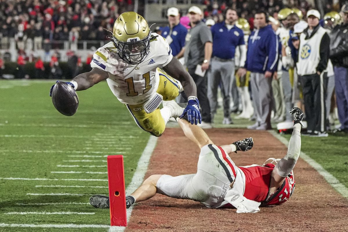 Nov 29, 2024; Athens, Georgia, USA; Georgia Tech Yellow Jackets running back Jamal Haynes (11) scores a touchdown past Georgia Bulldogs defensive back Dan Jackson (17) during the first half at Sanford Stadium. Mandatory Credit: Dale Zanine-Imagn Images