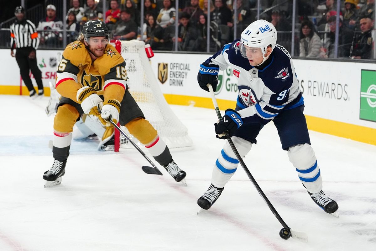 Nov 29, 2024; Las Vegas, Nevada, USA; Winnipeg Jets center Cole Perfetti (91) looks to make a pass in front of Vegas Golden Knights defenseman Noah Hanifin (15) during the first period at T-Mobile Arena. Mandatory Credit: Stephen R. Sylvanie-Imagn Images