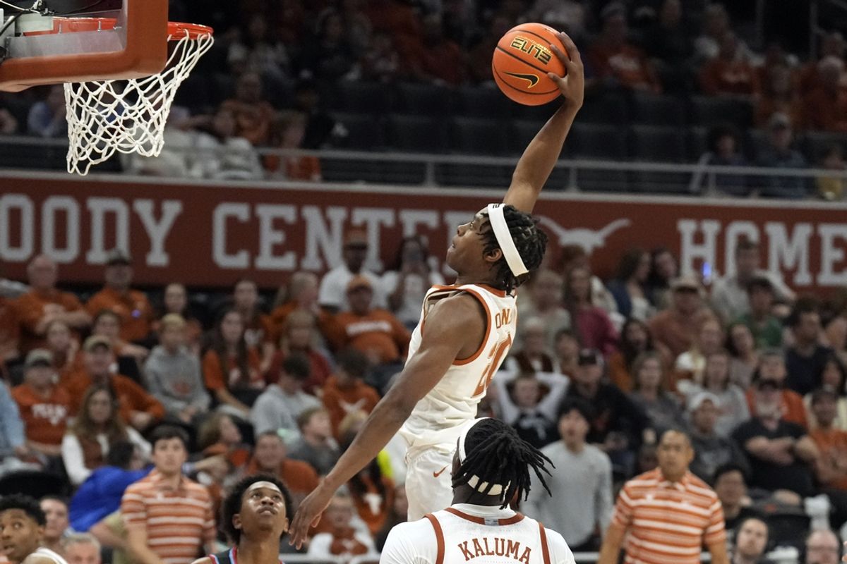 Nov 29, 2024; Austin, Texas, USA; Texas Longhorns guard Tre Johnson (20) dunks during the second half against the Delaware State Hornets at Moody Center. Mandatory Credit: Scott Wachter-Imagn Images