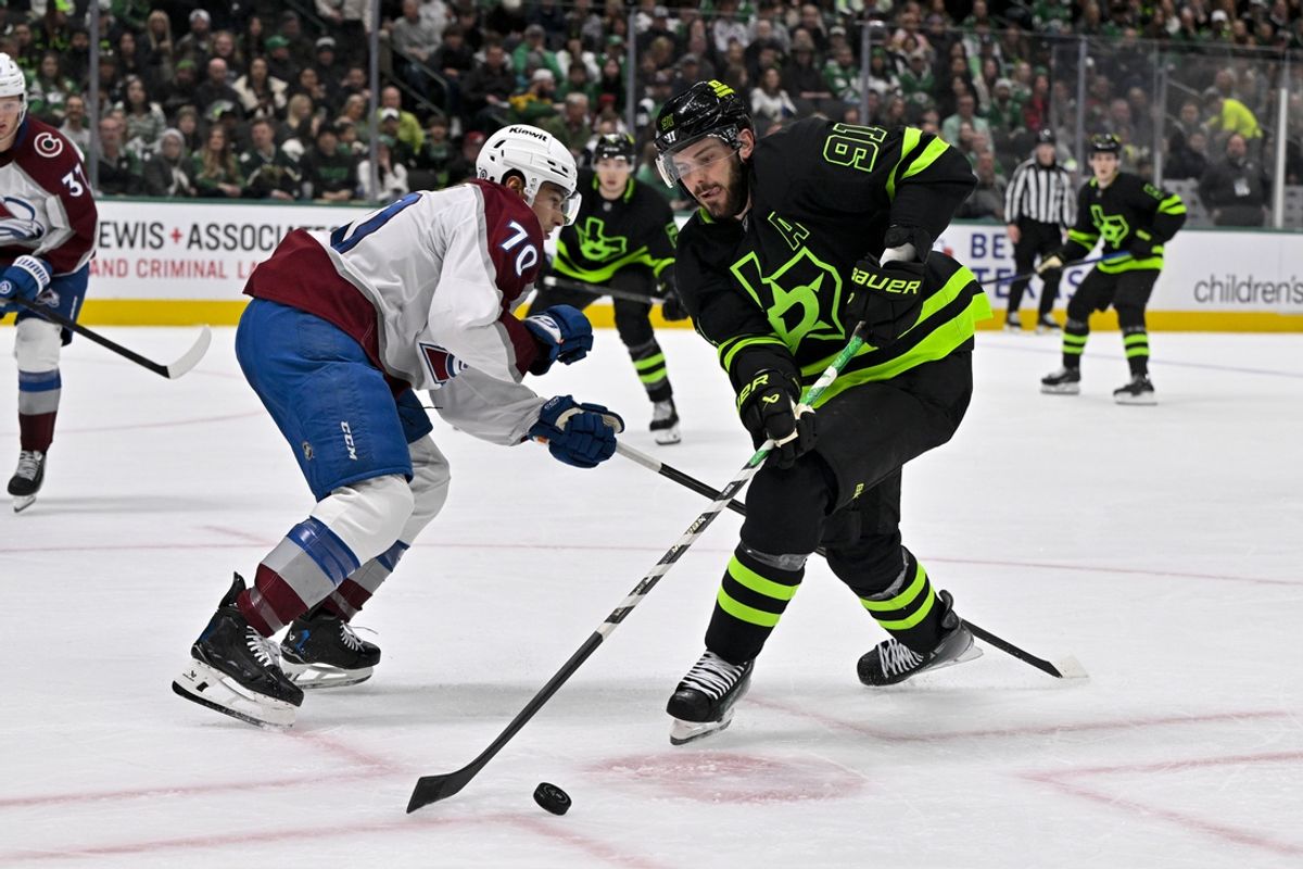 Nov 29, 2024; Dallas, Texas, USA; Dallas Stars center Tyler Seguin (91) moves the puck past Colorado Avalanche defenseman Sam Malinski (70) during the second period at the American Airlines Center. Mandatory Credit: Jerome Miron-Imagn Images