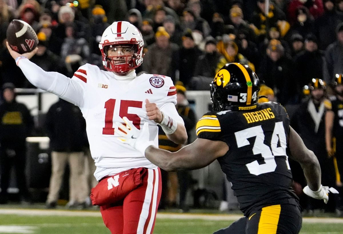 Nebraska Cornhuskers quarterback Dylan Raiola (15) passes as Iowa Hawkeyes linebacker Jay Higgins (34) defends Friday, Nov. 29, 2024 at Kinnick Stadium in Iowa City, Iowa.