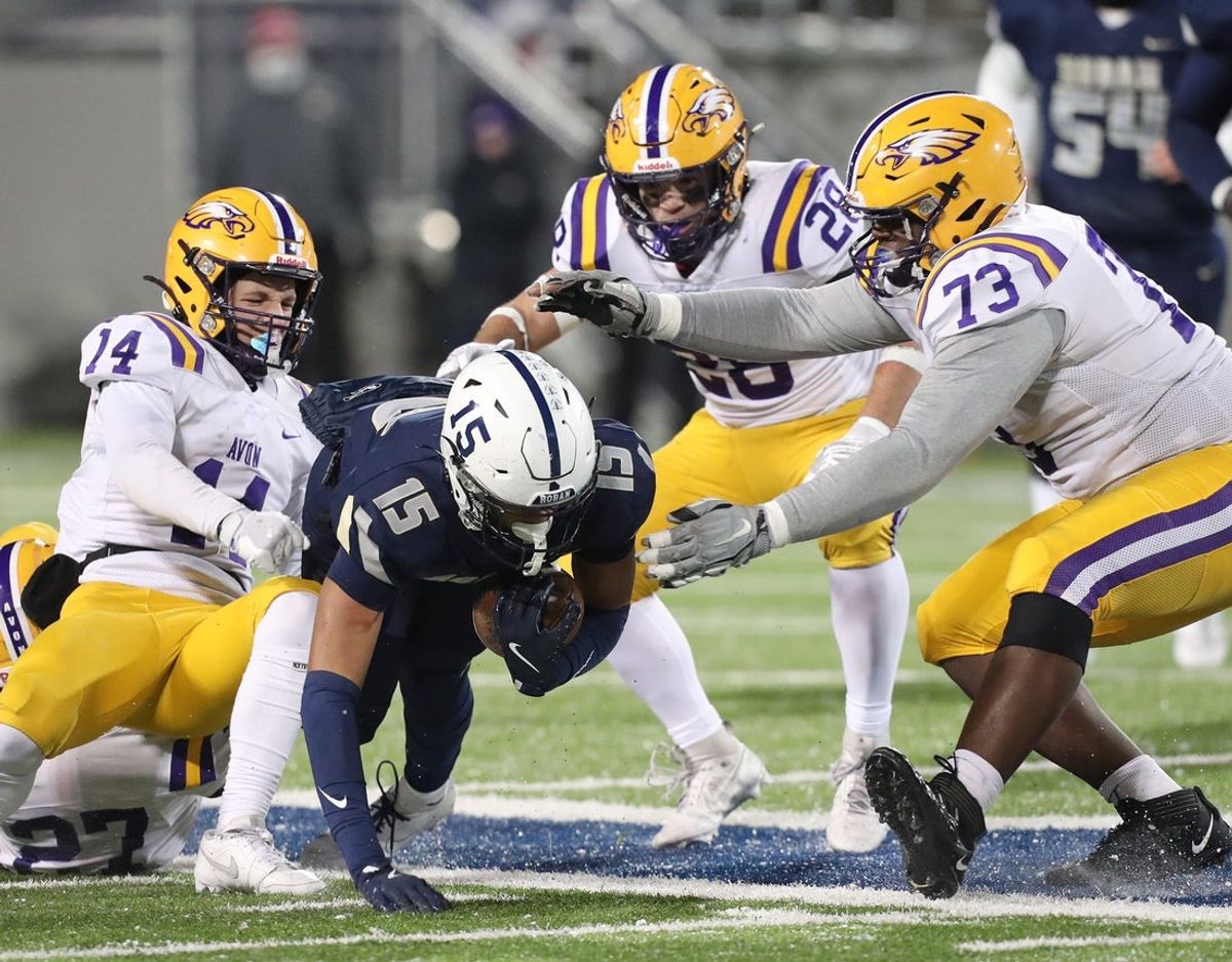 Avon defenders Caden Clapham, Merck Dunn and Jeremiah Kelly converge on Hoban tight end Tayte Crable after a reception during the Division II state semifinal, Friday, Nov. 29, 2024.