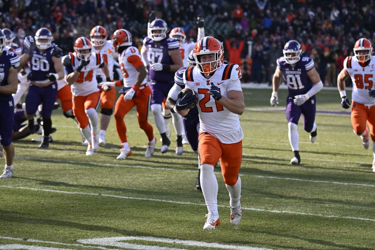 Nov 30, 2024; Chicago, Illinois, USA;  Illinois Fighting Illini running back Aidan Laughery (21) runs for a touchdown against Northwestern Wildcats during the first half at Wrigley Field. Mandatory Credit: Matt Marton-Imagn Images