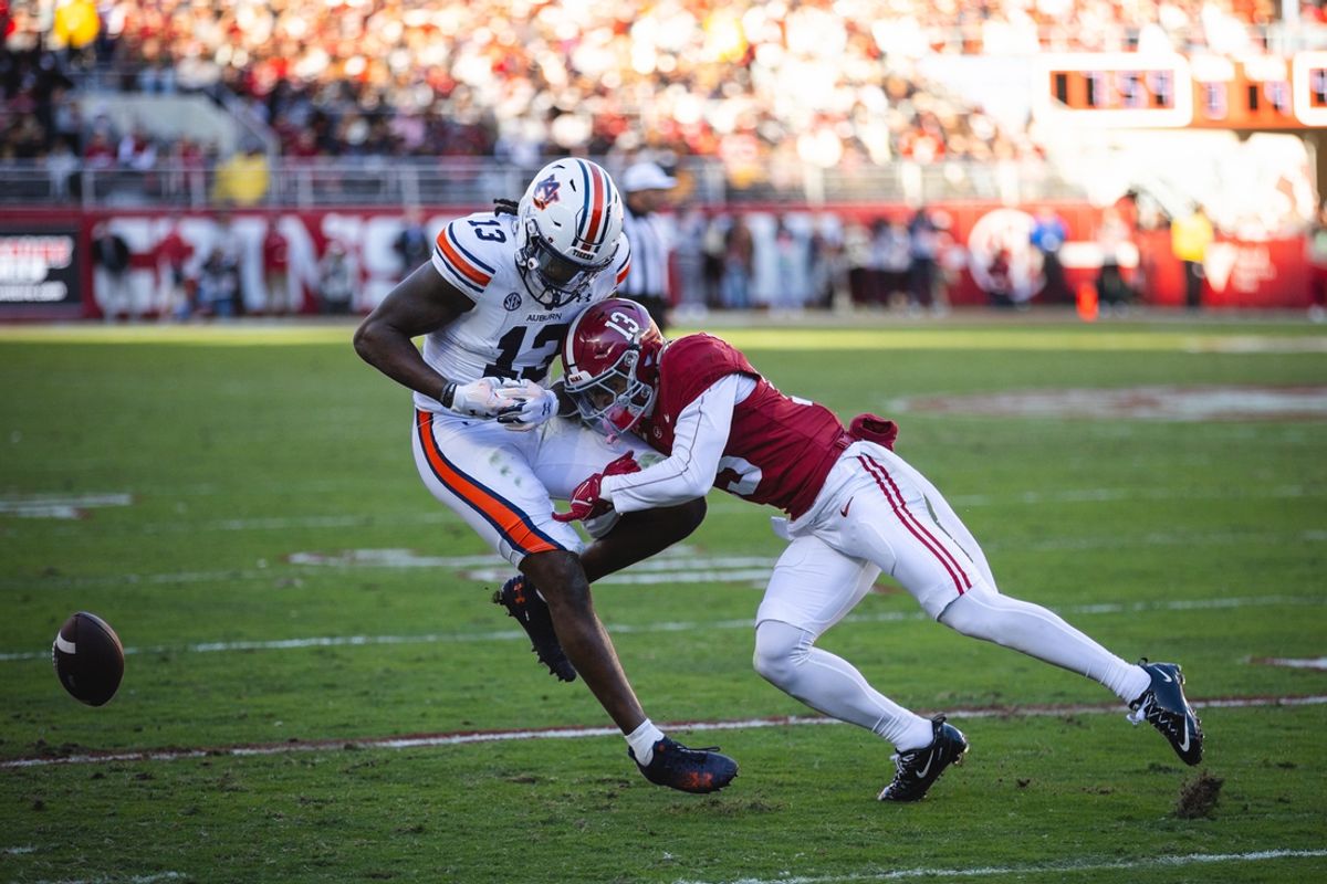 Nov 30, 2024; Tuscaloosa, Alabama, USA; Alabama Crimson Tide defensive back Malachi Moore (13) tackles Auburn Tigers tight end Rivaldo Fairweather (13) during the first quarter at Bryant-Denny Stadium. Mandatory Credit: Will McLelland-Imagn Images