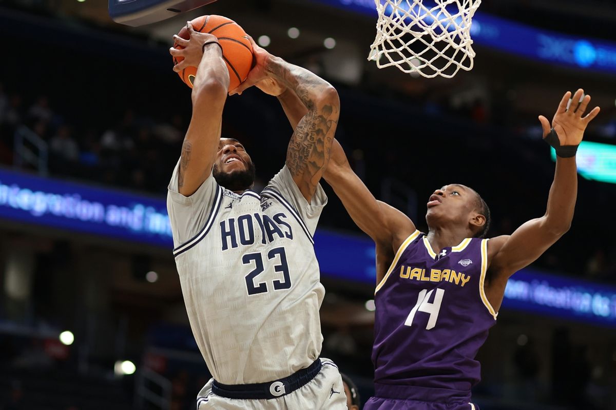 Nov 30, 2024; Washington, District of Columbia, USA; Georgetown Hoyas forward Jordan Burks (23) shoots the ball against Albany Great Danes guard Zach Matulu (14) during the first half at Capital One Arena. Mandatory Credit: Daniel Kucin Jr.-Imagn Images
