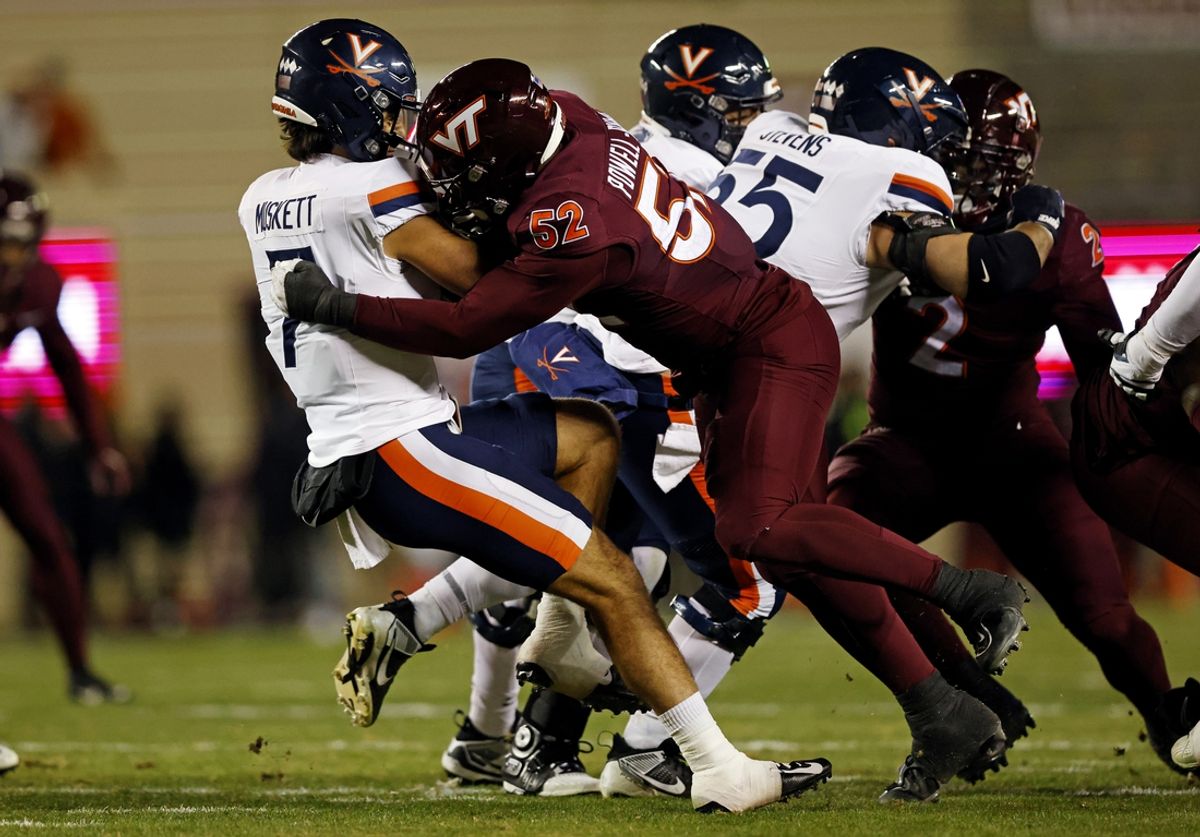 Nov 30, 2024; Blacksburg, Virginia, USA; Virginia Tech Hokies defensive lineman Antwaun Powell-Ryland (52) sacks Virginia Cavaliers quarterback Tony Muskett (7) during the first quarter at Lane Stadium. Mandatory Credit: Peter Casey-Imagn Images
