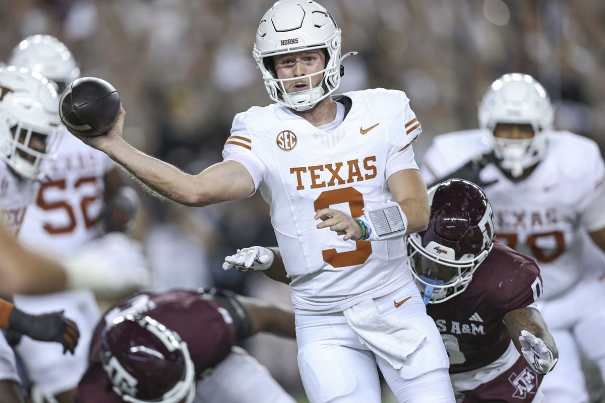 Nov 30, 2024; College Station, Texas, USA; Texas Longhorns quarterback Quinn Ewers (3) attempts a pass as Texas A&M Aggies linebacker Scooby Williams (0) applies defensive pressure during the first quarter at Kyle Field. Mandatory Credit: Troy Taormina-Imagn Images