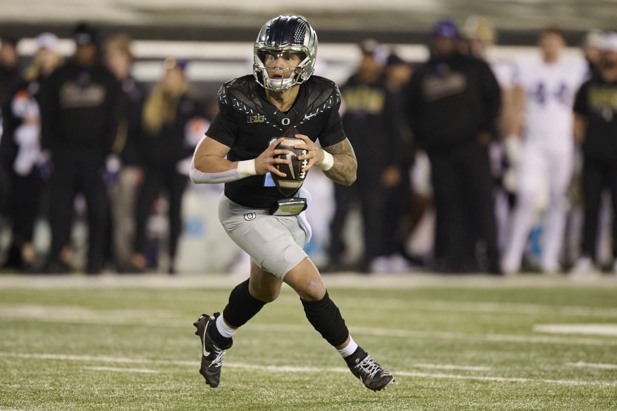 Nov 30, 2024; Eugene, Oregon, USA; Oregon Ducks quarterback Dillon Gabriel (8) looks for a receiver during the first half against the Washington Huskies at Autzen Stadium. Mandatory Credit: Troy Wayrynen-Imagn Images