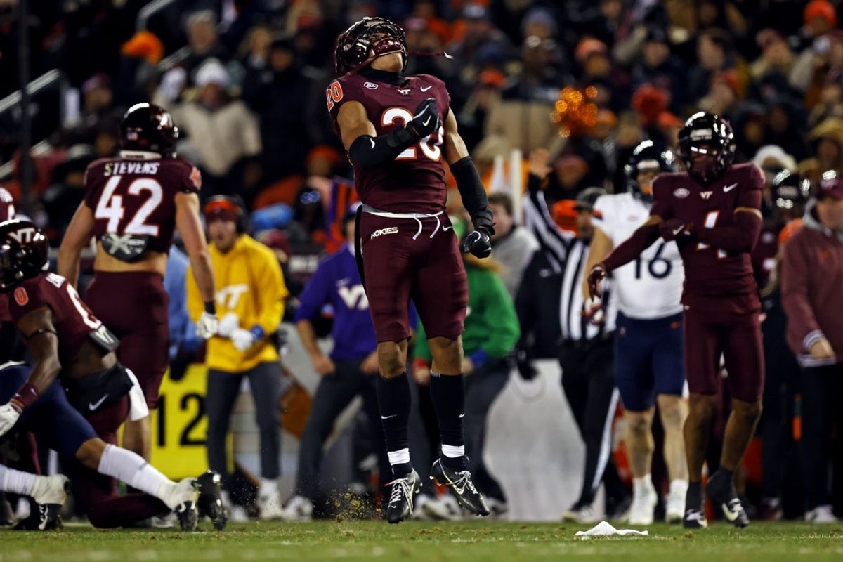 Nov 30, 2024; Blacksburg, Virginia, USA; Virginia Tech Hokies linebacker Caleb Woodson (20) celebrates after a play during the second quarter against the Virginia Cavaliers at Lane Stadium. Mandatory Credit: Peter Casey-Imagn Images