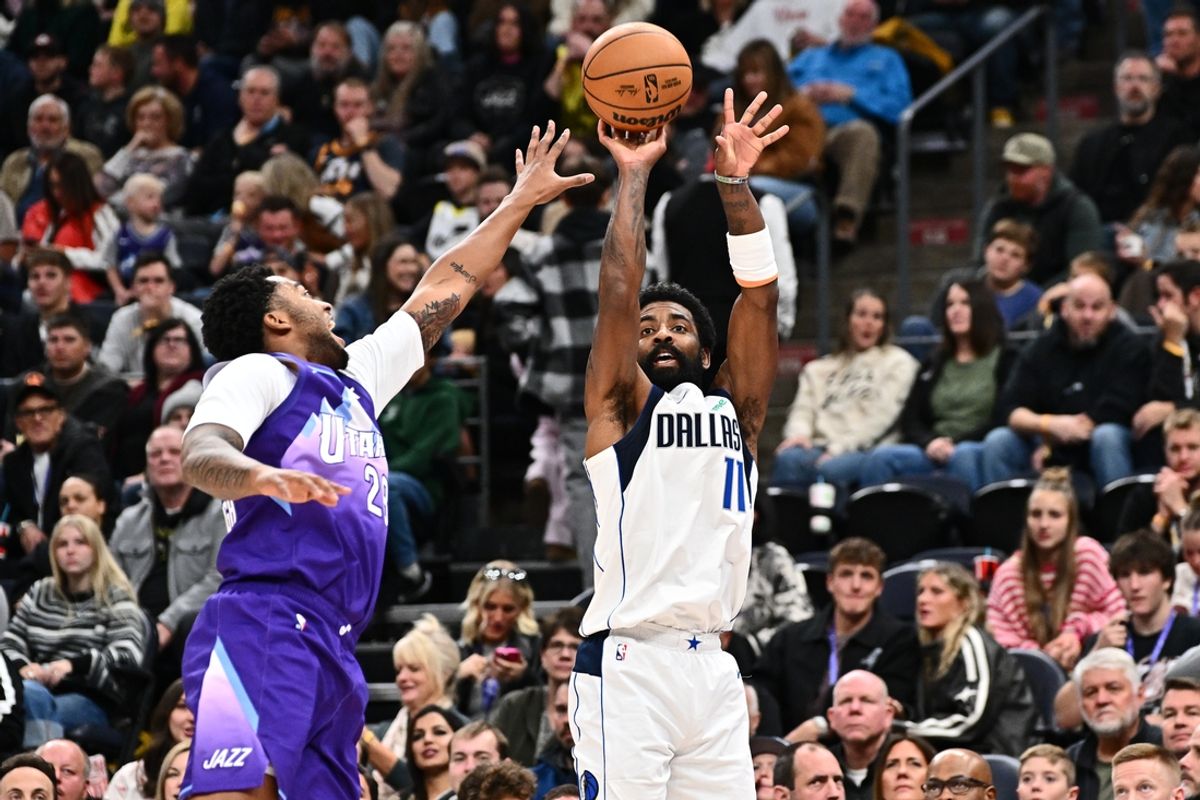 Nov 30, 2024; Salt Lake City, Utah, USA;  Dallas Mavericks guard Kyrie Irving (11) shoots for three points over the defense of Utah Jazz forward Brice Sensabaugh (28) in the first half at Delta Center. Mandatory Credit: Jamie Sabau-Imagn Images