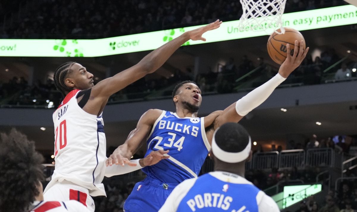 Nov 30, 2024; Milwaukee, Wisconsin, USA; Milwaukee Bucks forward Giannis Antetokounmpo (34) drives to the basket against Washington Wizards forward Alexandre Sarr (20) in the first half at Fiserv Forum. Mandatory Credit: Michael McLoone-Imagn Images