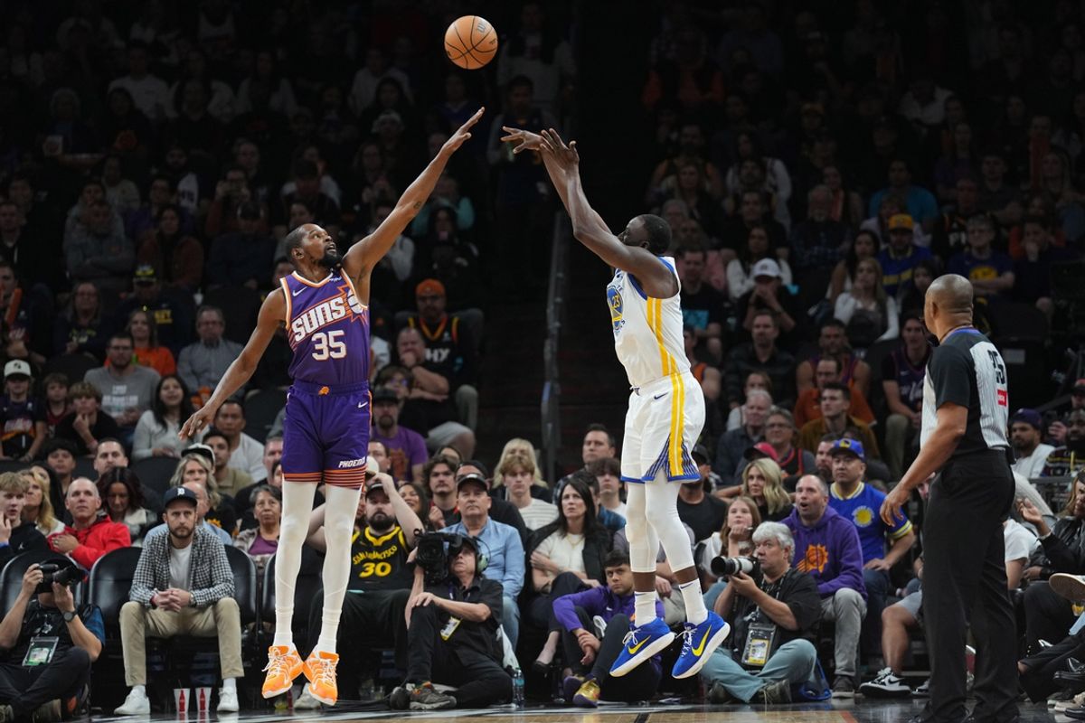 Nov 30, 2024; Phoenix, Arizona, USA; Golden State Warriors forward Draymond Green (23) shoots over Phoenix Suns forward Kevin Durant (35) during the second half at Footprint Center. Mandatory Credit: Joe Camporeale-Imagn Images