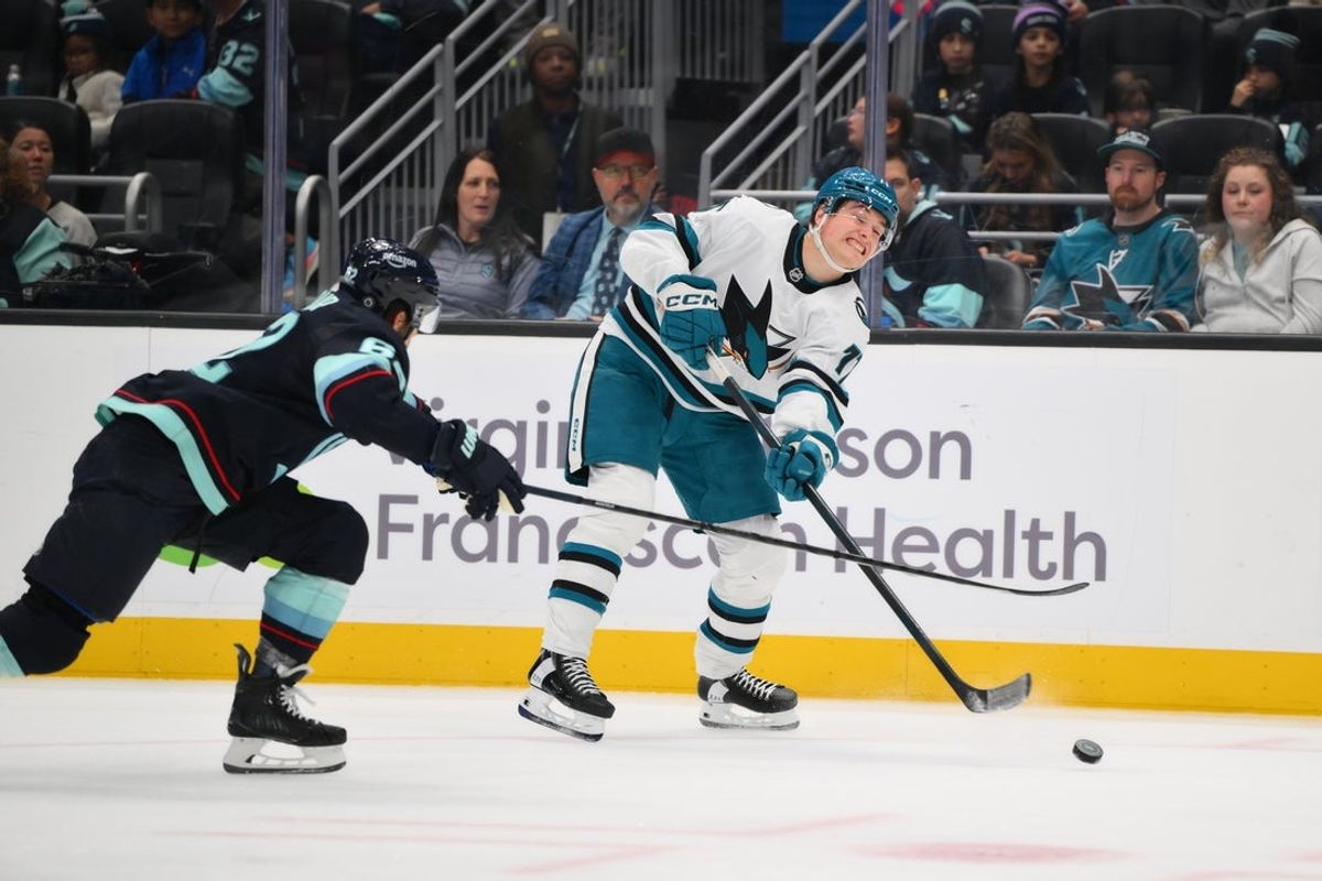Nov 30, 2024; Seattle, Washington, USA; San Jose Sharks center Macklin Celebrini (71) passes the puck during the third period against the Seattle Kraken at Climate Pledge Arena. Mandatory Credit: Steven Bisig-Imagn Images