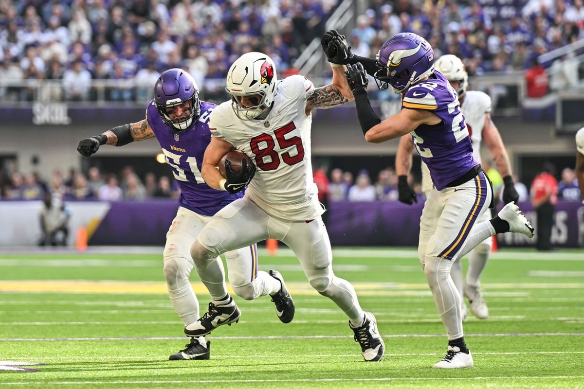Dec 1, 2024; Minneapolis, Minnesota, USA; Arizona Cardinals tight end Trey McBride (85) fights off the tackle of Minnesota Vikings safety Harrison Smith (22) and linebacker Blake Cashman (51) during the second quarter at U.S. Bank Stadium. Mandatory Credit: Jeffrey Becker-Imagn Images