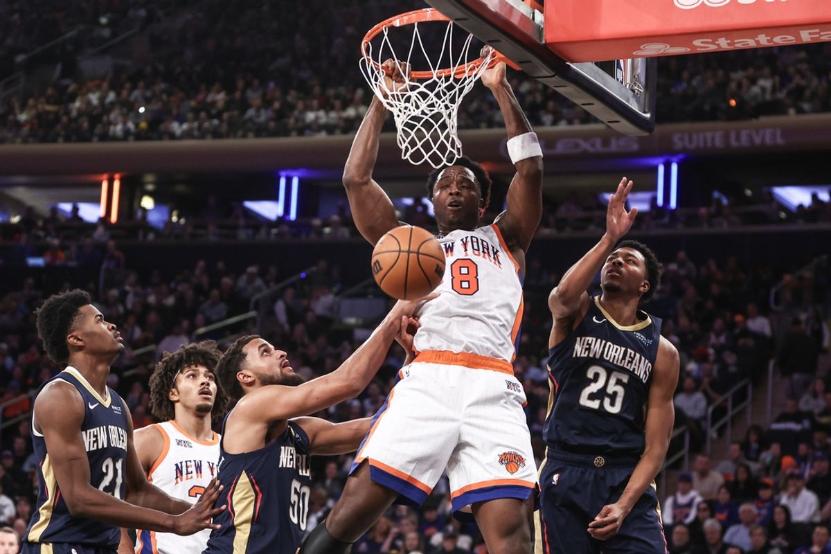 Dec 1, 2024; New York, New York, USA;  New York Knicks forward OG Anunoby (8) dunks past New Orleans Pelicans forward Jeremiah Robinson-Earl (50) and guard Trey Murphy III (25) in the second quarter at Madison Square Garden. Mandatory Credit: Wendell Cruz-Imagn Images