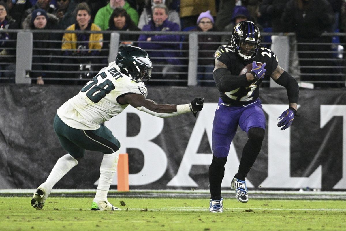 Dec 1, 2024; Baltimore, Maryland, USA; Baltimore Ravens running back Derrick Henry (22) rushes by Philadelphia Eagles linebacker Jalyx Hunt (58) during the second  half  at M&T Bank Stadium. Mandatory Credit: Tommy Gilligan-Imagn Images