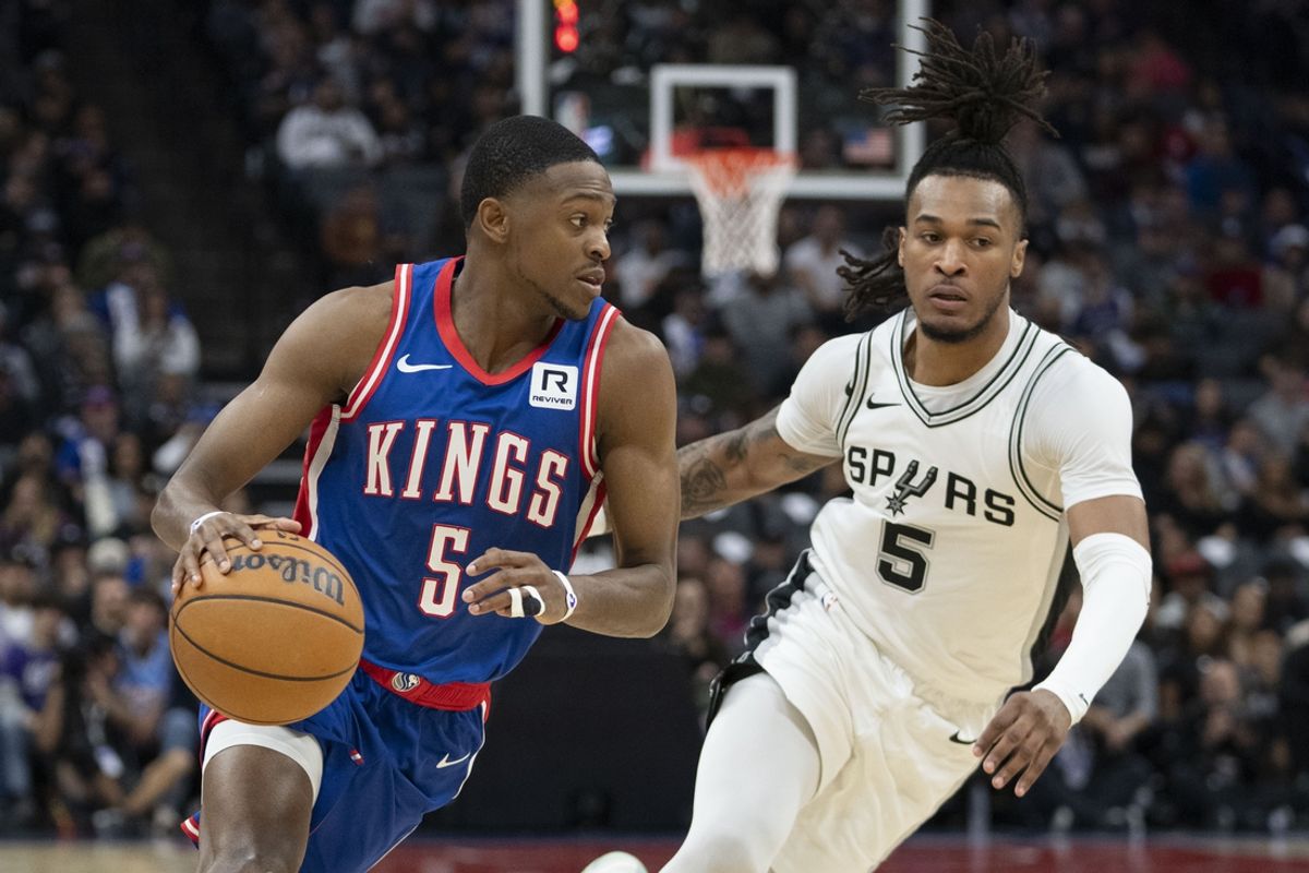 December 1, 2024; Sacramento, California, USA; Sacramento Kings guard De'Aaron Fox (5) dribbles the basketball against San Antonio Spurs guard Stephon Castle (5) during the second quarter at Golden 1 Center. Mandatory Credit: Kyle Terada-Imagn Images