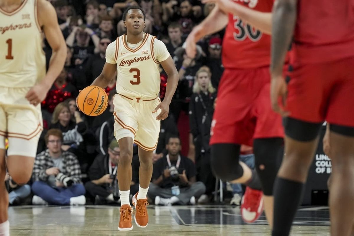 Jan 9, 2024; Cincinnati, Ohio, USA;  Texas Longhorns guard Max Abmas (3) dribbles the ball against the Cincinnati Bearcats in the second half at Fifth Third Arena.