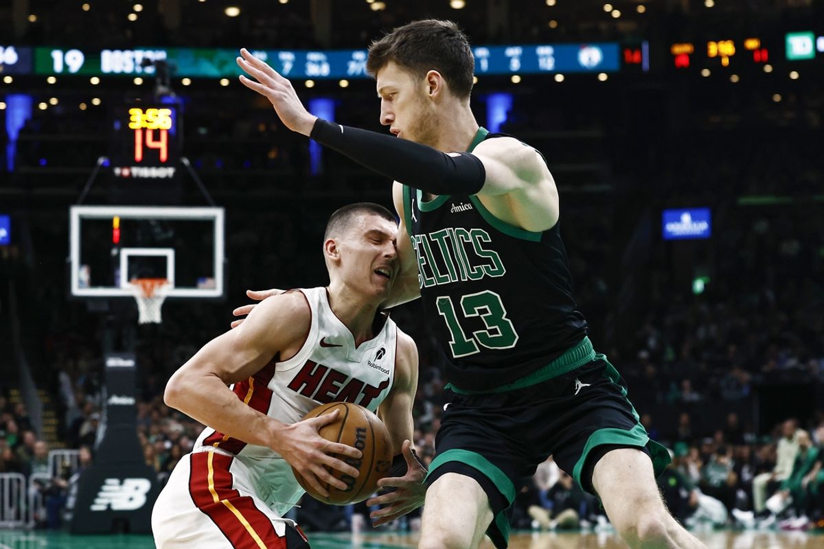 Dec 2, 2024; Boston, Massachusetts, USA; Miami Heat guard Tyler Herro (14) runs into Boston Celtics forward Drew Peterson (13) during the first quarter at TD Garden. Mandatory Credit: Winslow Townson-Imagn Images