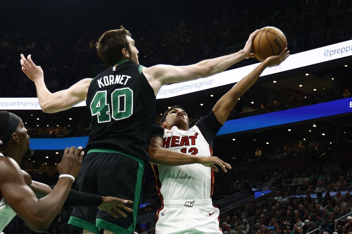 Dec 2, 2024; Boston, Massachusetts, USA; Boston Celtics center Luke Kornet (40) blocks a shot by Miami Heat guard Dru Smith (12) during the second quarter at TD Garden. Mandatory Credit: Winslow Townson-Imagn Images
