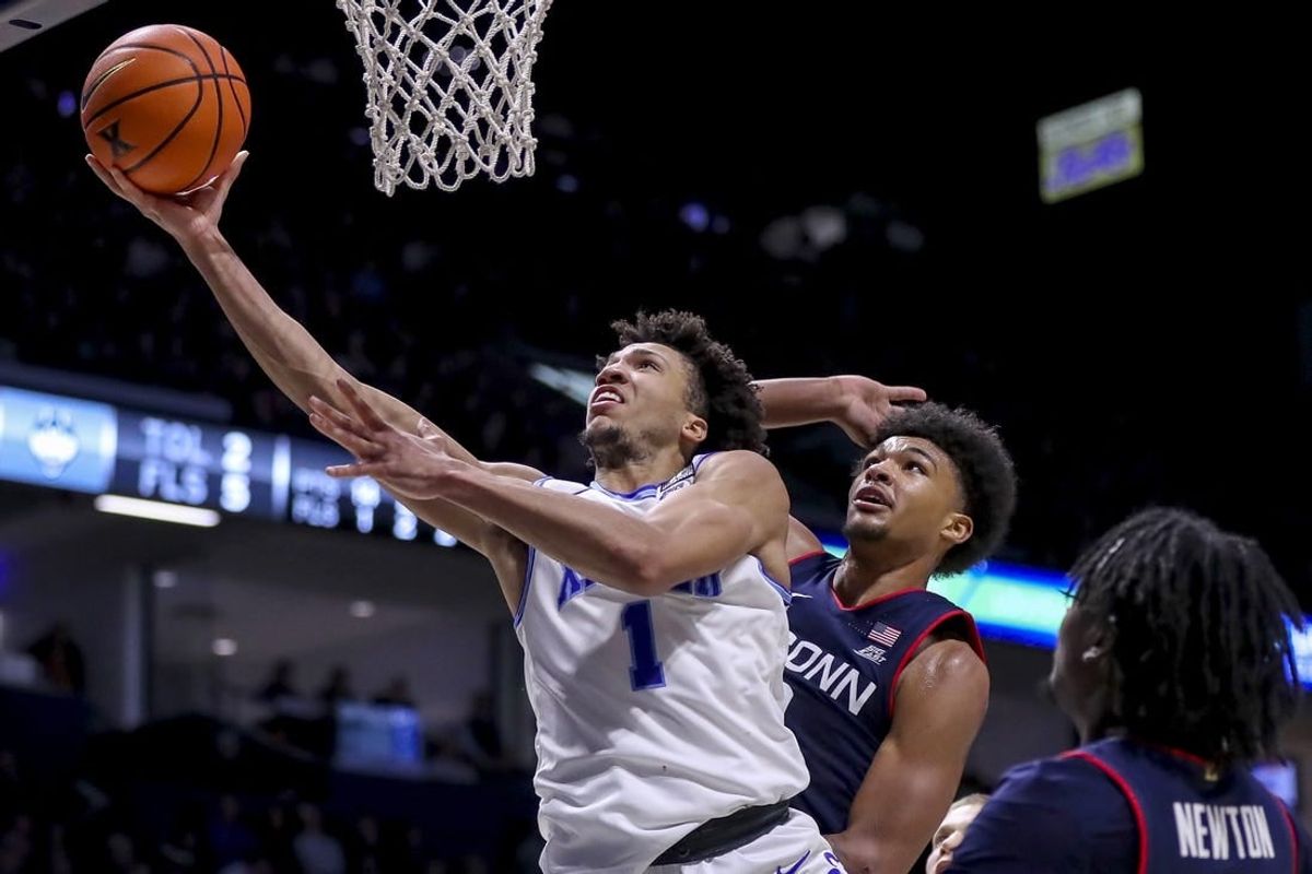 Jan 10, 2024; Cincinnati, Ohio, USA; Xavier Musketeers guard Desmond Claude (1) shoots against Connecticut Huskies forward Jaylin Stewart (3) in the second half at Cintas Center.
