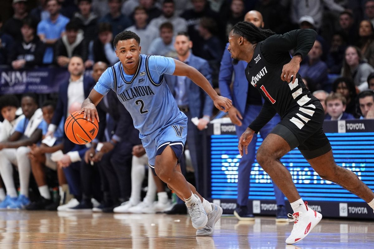 Dec 3, 2024; Villanova, Pennsylvania, USA; Villanova Wildcats guard Jhamir Brickus (2) drives against Cincinnati Bearcats guard Day Day Thomas (1) in the first half at William B. Finneran Pavilion. Mandatory Credit: Kyle Ross-Imagn Images