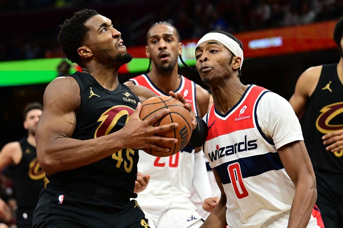 Dec 3, 2024; Cleveland, Ohio, USA; Cleveland Cavaliers guard Donovan Mitchell (45) drives to the basket against Washington Wizards guard Bilal Coulibaly (0) during the second half at Rocket Mortgage FieldHouse. Mandatory Credit: Ken Blaze-Imagn Images