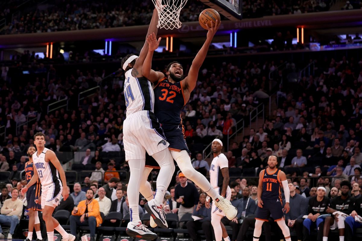 Dec 3, 2024; New York, New York, USA; New York Knicks center Karl-Anthony Towns (32) drives to the basket against Orlando Magic center Wendell Carter Jr. (34) during the third quarter at Madison Square Garden. Mandatory Credit: Brad Penner-Imagn Images