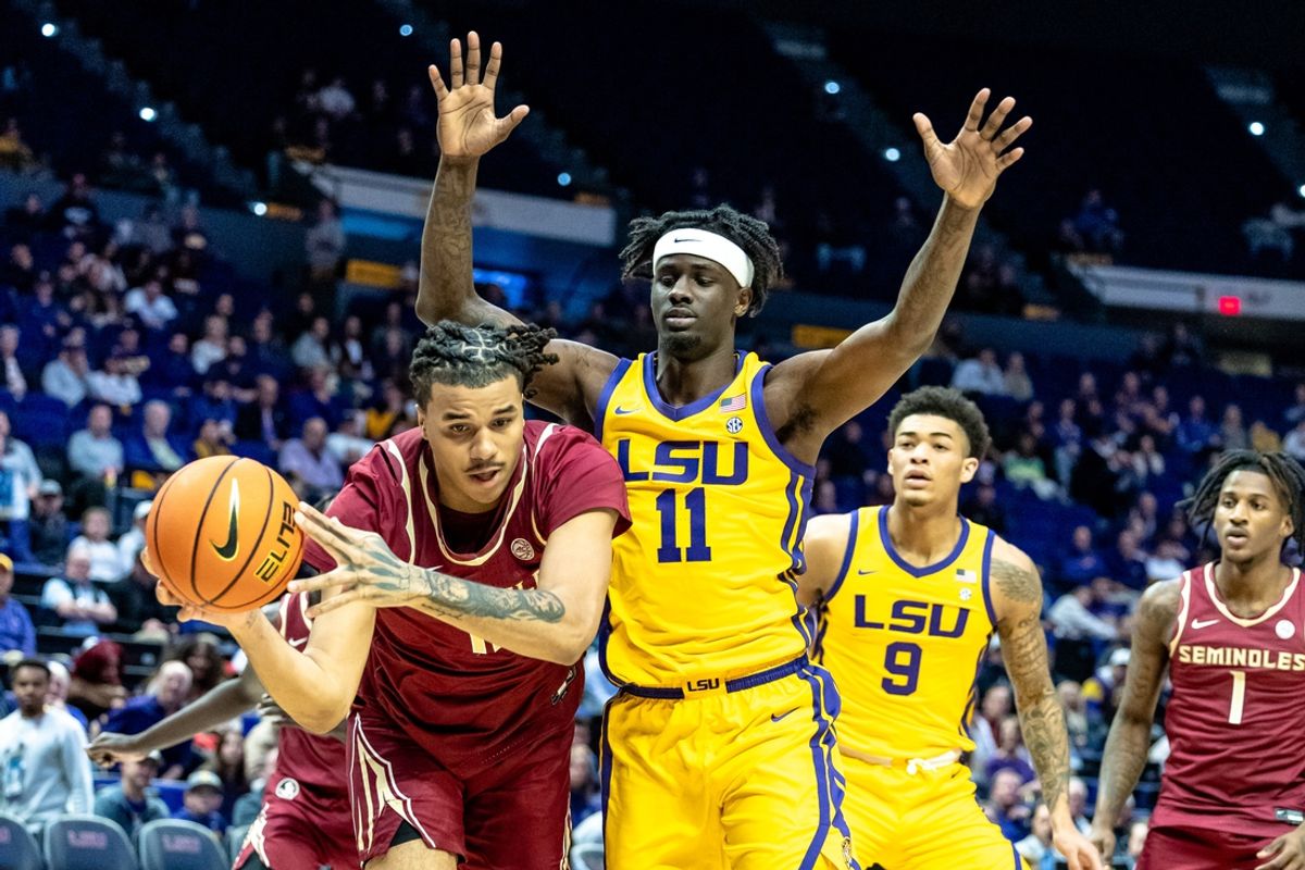 Dec 3, 2024; Baton Rouge, Louisiana, USA;  Florida State Seminoles forward Malique Ewin (12) goes for a loose ball against LSU Tigers forward Corey Chest (11) during the first half at Pete Maravich Assembly Center. Mandatory Credit: Stephen Lew-Imagn Images