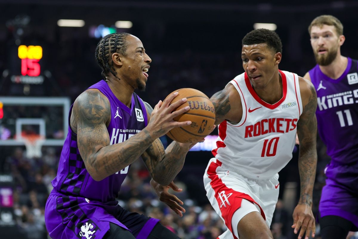 Dec 3, 2024; Sacramento, California, USA; Sacramento Kings forward DeMar DeRozan (10) controls the ball against Houston Rockets forward Jabari Smith Jr. (10) during the first quarter at Golden 1 Center. Mandatory Credit: Sergio Estrada-Imagn Images