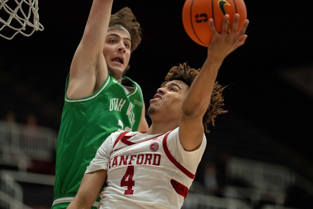 Dec 3, 2024; Stanford, California, USA; Stanford Cardinal guard Oziyah Sellers (4) shoots a layup against Utah Valley Wolverines guard Dylan Metoyer (23) during the first quarter at Maples Pavilion. Mandatory Credit: Neville E. Guard-Imagn Images