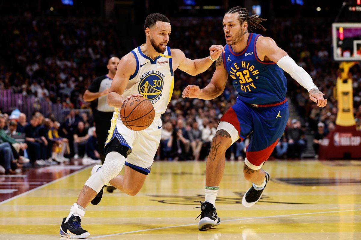 Dec 3, 2024; Denver, Colorado, USA; Golden State Warriors guard Stephen Curry (30) controls the ball as Denver Nuggets forward Aaron Gordon (32) guards in the second quarter at Ball Arena. Mandatory Credit: Isaiah J. Downing-Imagn Images