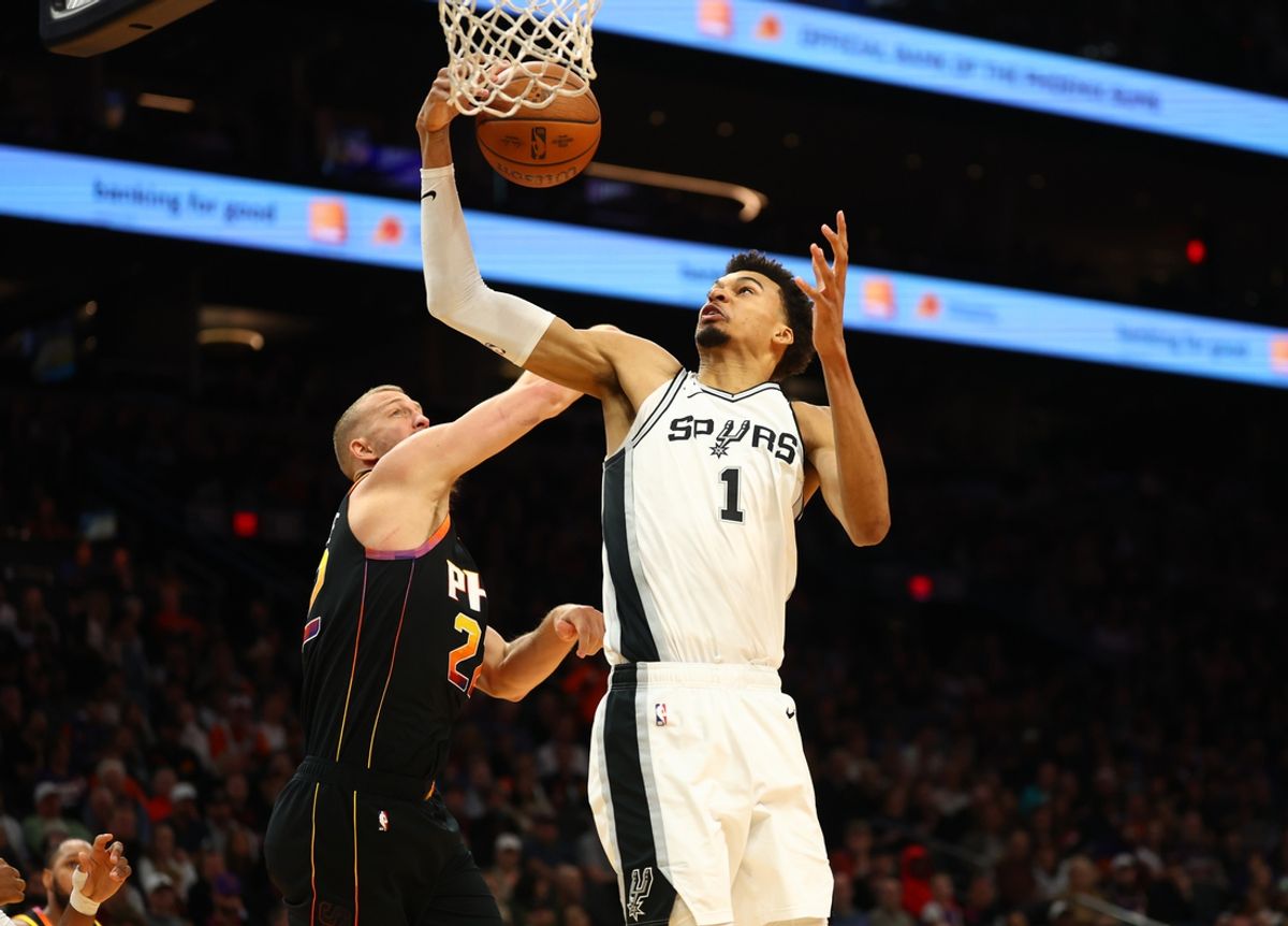 Dec 3, 2024; Phoenix, Arizona, USA; San Antonio Spurs center Victor Wembanyama (1) grabs a rebound against the Phoenix Suns in the second half of an NBA Cup game at Footprint Center. Mandatory Credit: Mark J. Rebilas-Imagn Images