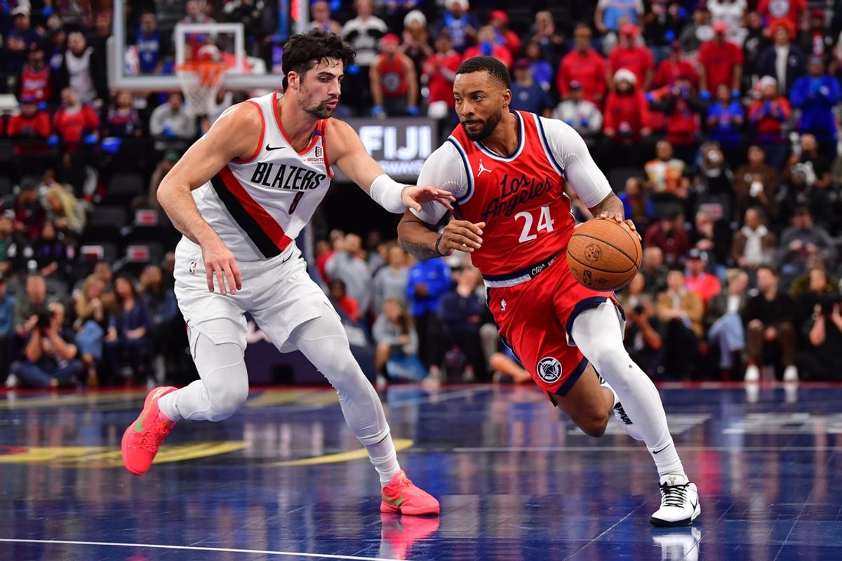 Dec 3, 2024; Inglewood, California, USA; Los Angeles Clippers guard Norman Powell (24) moves the ball against Portland Trail Blazers forward Deni Avdija (8) during the first half at Intuit Dome. Mandatory Credit: Gary A. Vasquez-Imagn Images
