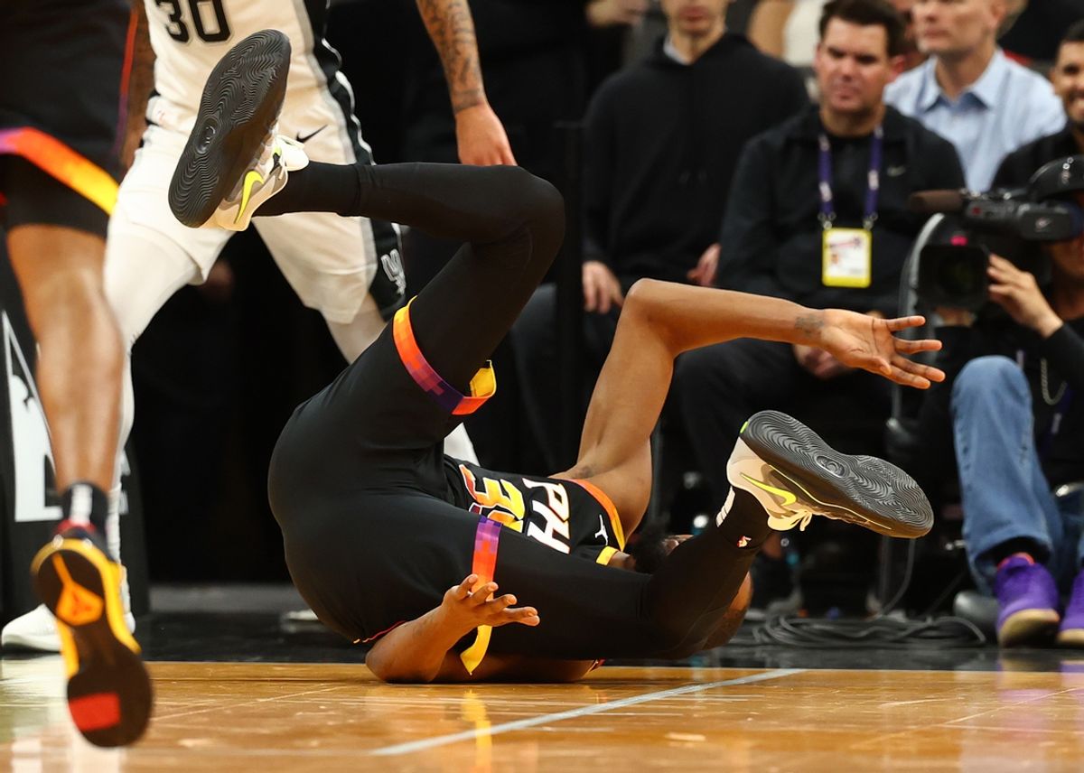 Dec 3, 2024; Phoenix, Arizona, USA; Phoenix Suns forward Kevin Durant (35) falls to the ground after rolling his ankle against the San Antonio Spurs in the first half of an NBA Cup game at Footprint Center. Mandatory Credit: Mark J. Rebilas-Imagn Images