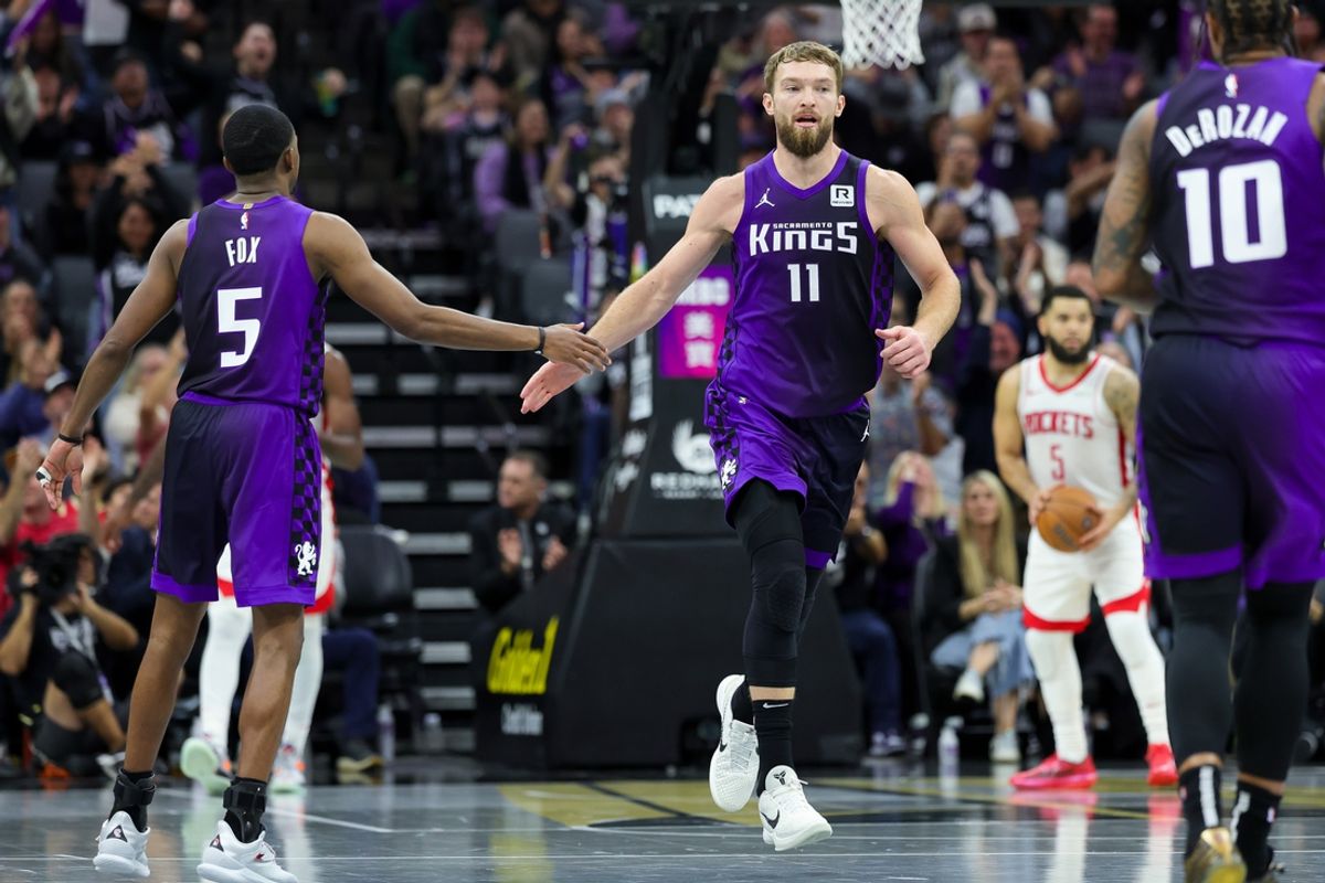 Dec 3, 2024; Sacramento, California, USA; Sacramento Kings forward Domantas Sabonis (11) shakes hands with guard De'Aaron Fox (5) during the fourth quarter against the Houston Rockets at Golden 1 Center. Mandatory Credit: Sergio Estrada-Imagn Images