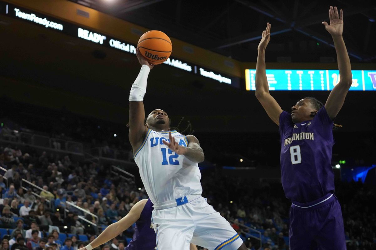Dec 3, 2024; Los Angeles, California, USA; UCLA Bruins guard Sebastian Mack (12) shoots the ball against Washington Huskies guard Tyler Harris (8) in the second half at Pauley Pavilion presented by Wescom. Mandatory Credit: Kirby Lee-Imagn Images