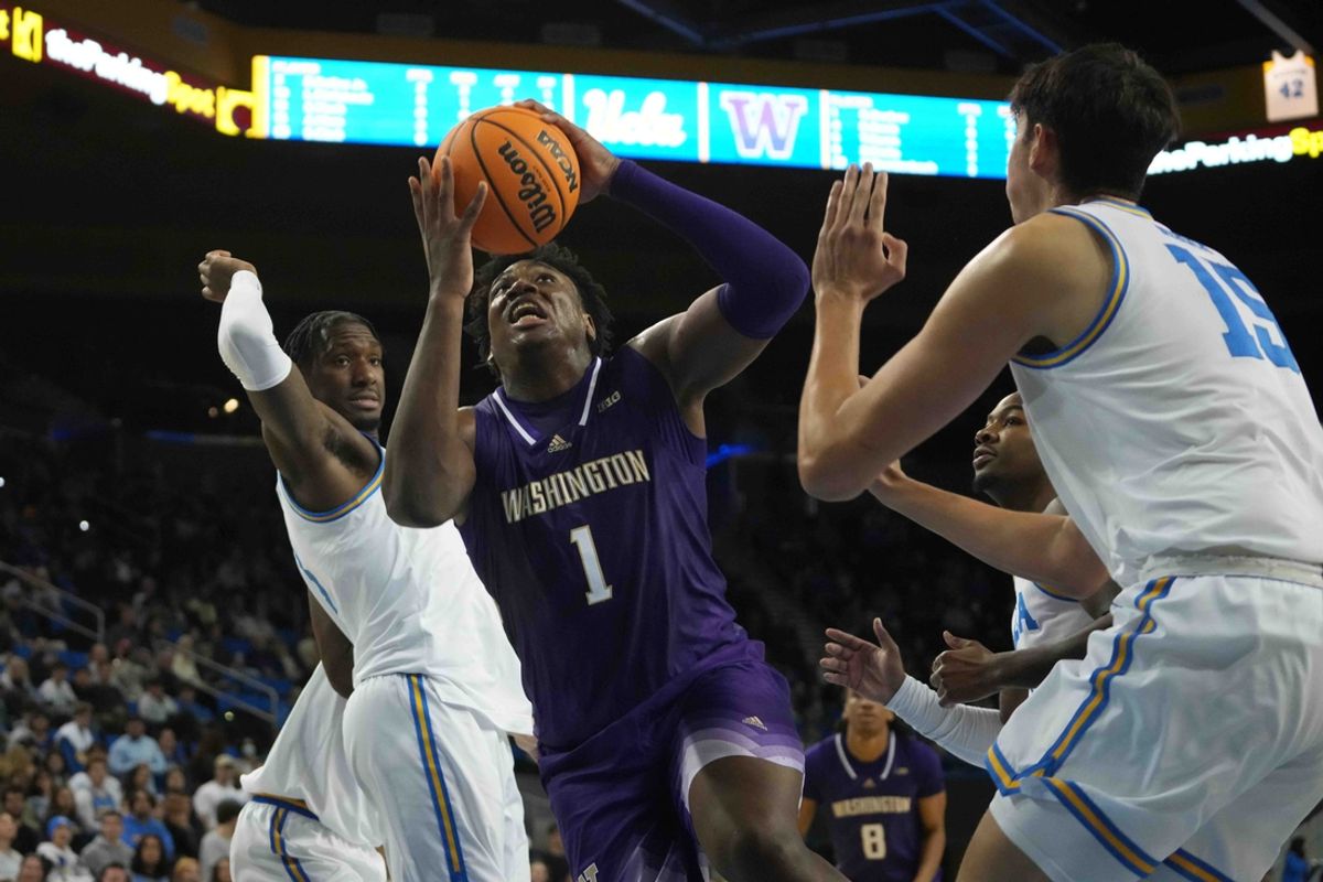 Dec 3, 2024; Los Angeles, California, USA; Washington Huskies forward Great Osobor (1) shoots the ball against UCLA Bruins guard Eric Dailey Jr. (3) and center Aday Mara (15) in the first half at Pauley Pavilion presented by Wescom. Mandatory Credit: Kirby Lee-Imagn Images