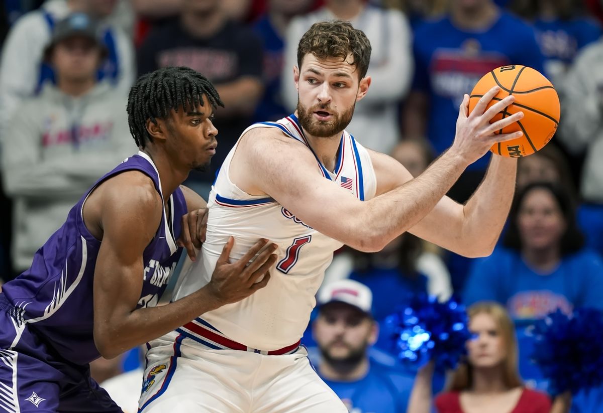Nov 30, 2024; Lawrence, Kansas, USA; Kansas Jayhawks center Hunter Dickinson (1) looks to pass against Furman Paladins forward Cooper Bowser (21) during the first half at Allen Fieldhouse. Mandatory Credit: Jay Biggerstaff-Imagn Images
