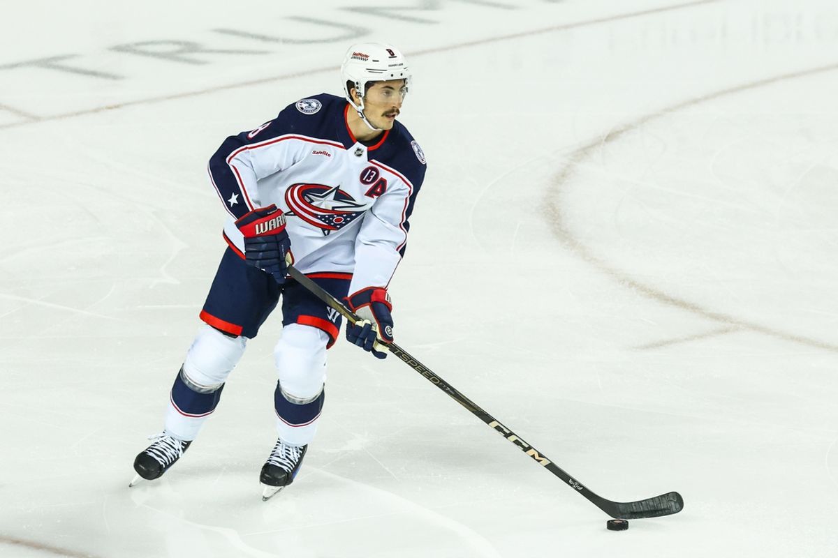 Dec 3, 2024; Calgary, Alberta, CAN; Columbus Blue Jackets defenseman Zach Werenski (8) skates with the puck against the Calgary Flames during the first period at Scotiabank Saddledome. Mandatory Credit: Sergei Belski-Imagn Images