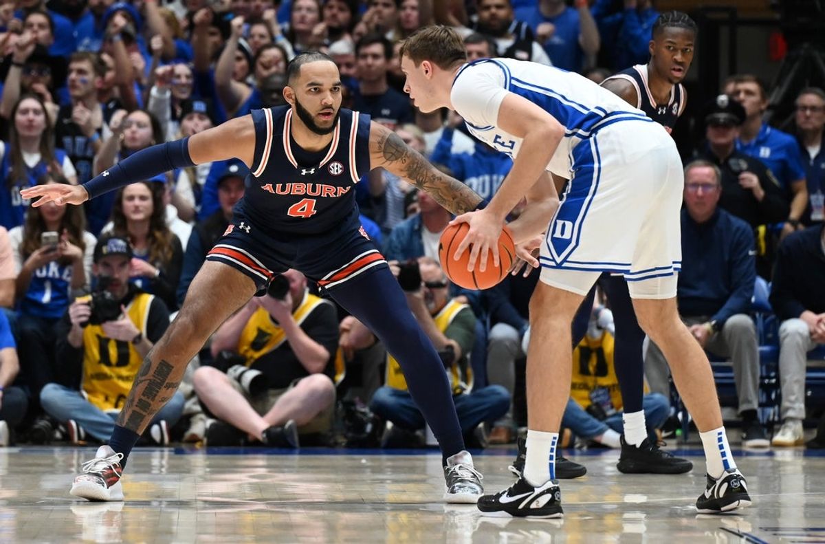 Dec 4, 2024; Durham, North Carolina, USA; Duke Blue Devils forward Cooper Flagg (2) controls the ball in front of Auburn Tigers center Johni Broome (4) during the first half at Cameron Indoor Stadium. Mandatory Credit: Rob Kinnan-Imagn Images