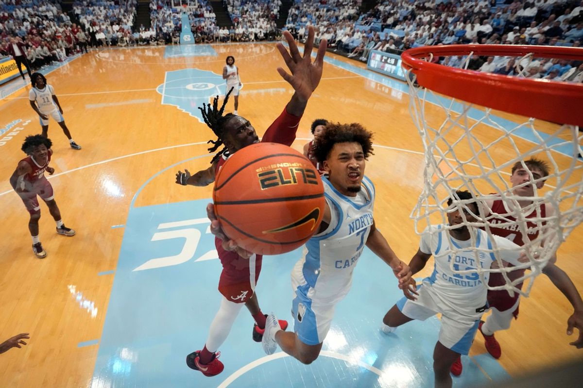 Dec 4, 2024; Chapel Hill, North Carolina, USA;  North Carolina Tar Heels guard Seth Trimble (7) shoots as Alabama Crimson Tide center Clifford Omoruyi (11) defends in the second half at Dean E. Smith Center. Mandatory Credit: Bob Donnan-Imagn Images