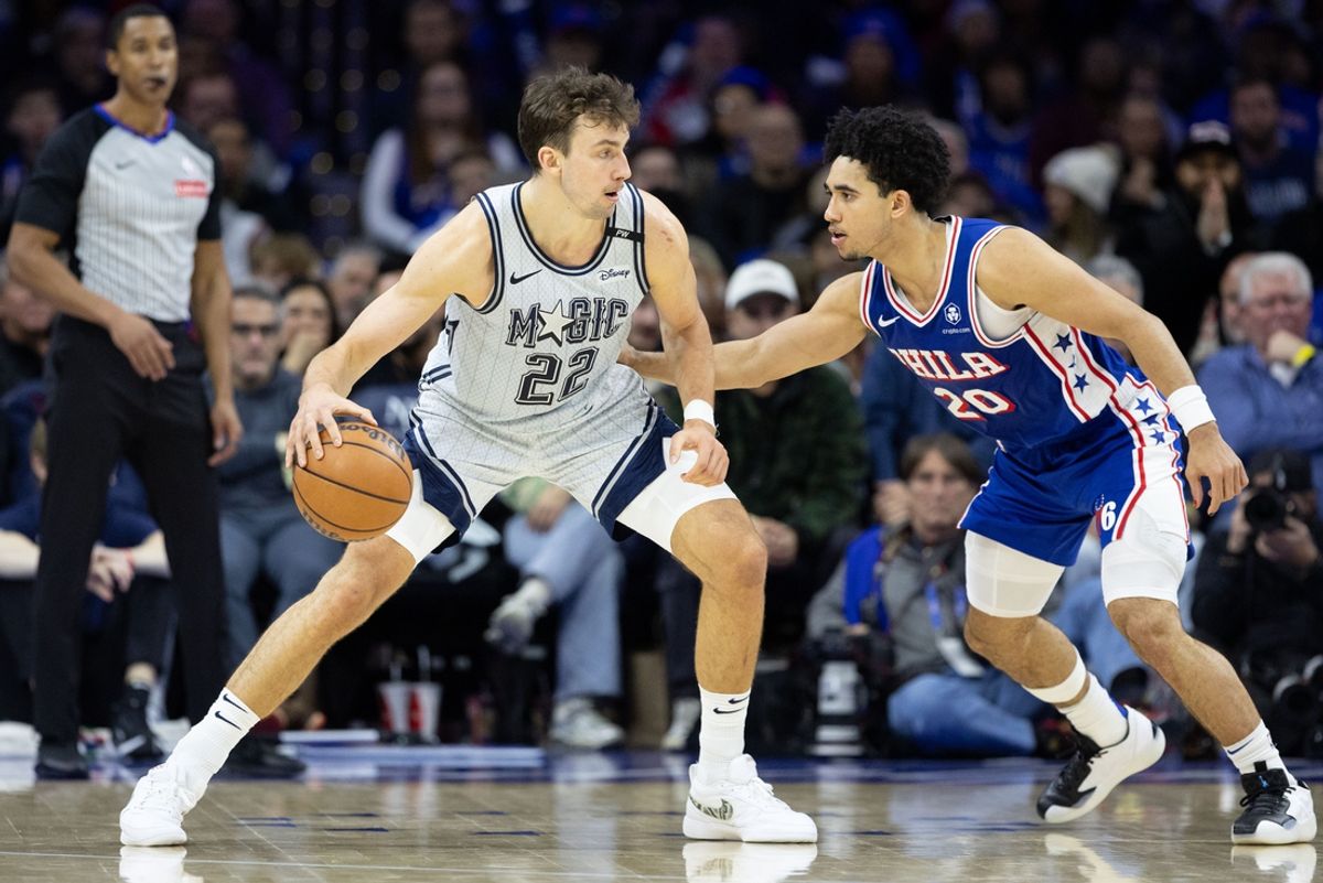 Dec 4, 2024; Philadelphia, Pennsylvania, USA; Orlando Magic forward Franz Wagner (22) controls the ball against Philadelphia 76ers guard Jared McCain (20) during the fourth quarter at Wells Fargo Center. Mandatory Credit: Bill Streicher-Imagn Images