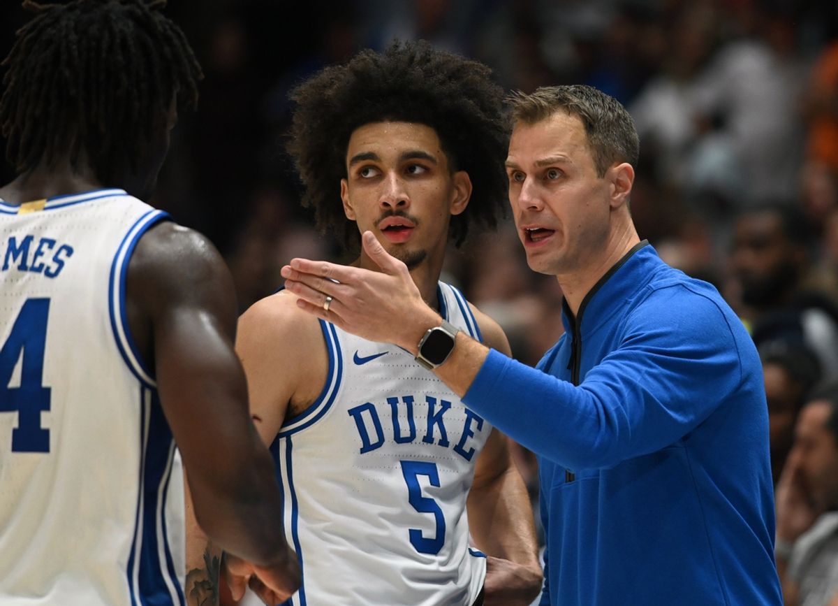 Dec 4, 2024; Durham, North Carolina, USA; Duke Blue Devils head coach Jon Scheyer (right) directs guard Tyrese Proctor (5) and guard Sion James (14) during the second half against the Auburn Tigers at Cameron Indoor Stadium.  The Blue Devils won 84-78.   Mandatory Credit: Rob Kinnan-Imagn Images