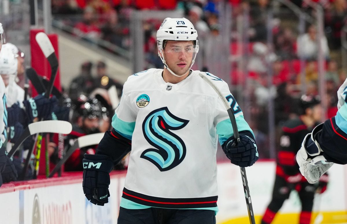 Dec 3, 2024; Raleigh, North Carolina, USA;  Seattle Kraken defenseman Vince Dunn (29) goes past the bench after a Kraken goal against the Carolina Hurricanes during the first period at Lenovo Center. Mandatory Credit: James Guillory-Imagn Images