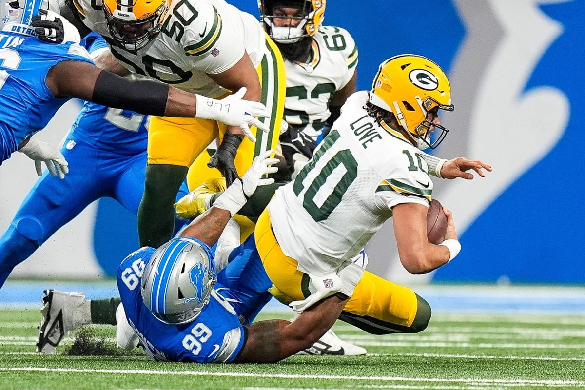 Detroit Lions defensive end Za'Darius Smith (99) sacks Green Bay Packers quarterback Jordan Love (10) during the first half at Ford Field in Detroit on Thursday, Dec. 5, 2024.