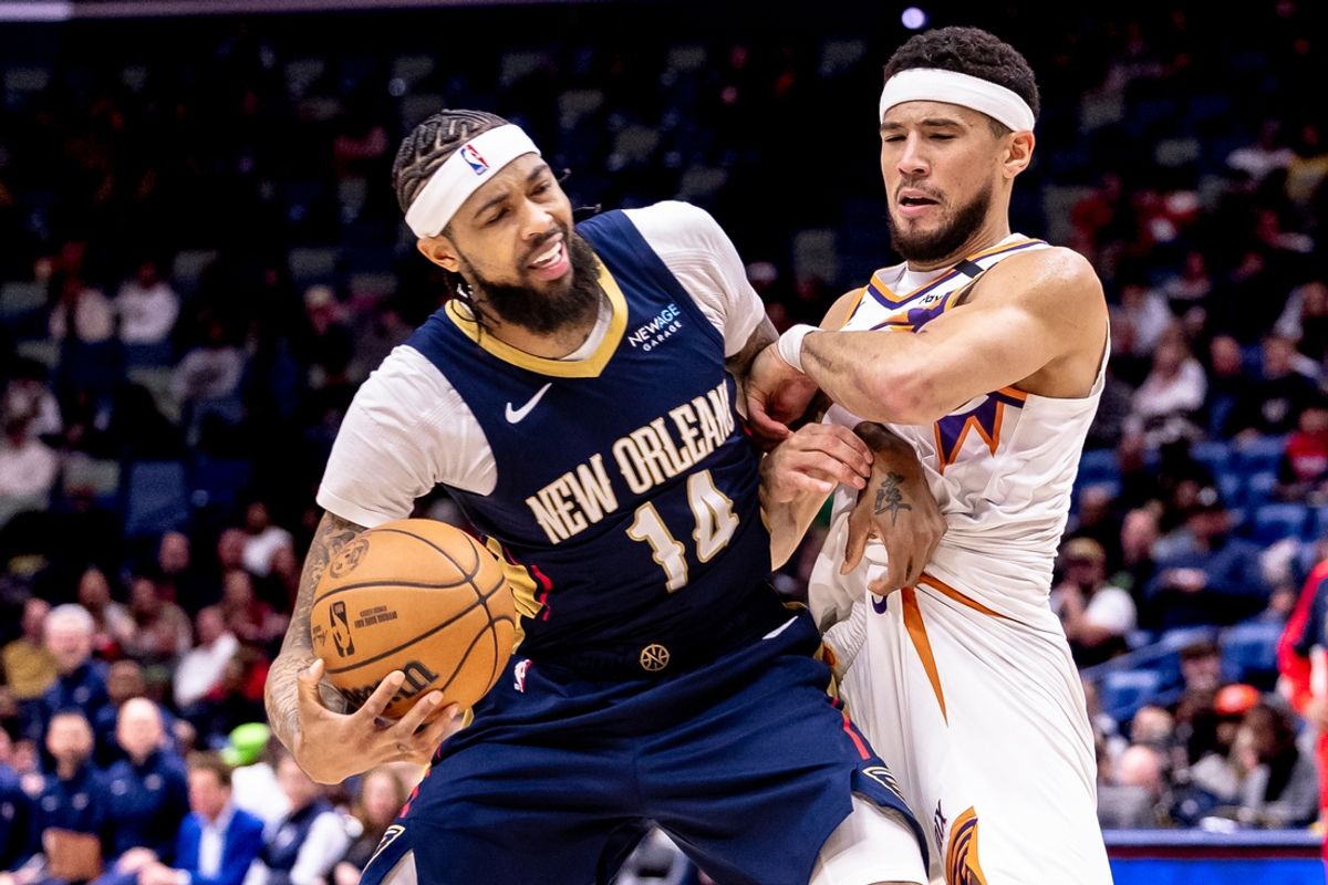 Dec 5, 2024; New Orleans, Louisiana, USA;  New Orleans Pelicans forward Brandon Ingram (14) is fouled by Phoenix Suns guard Devin Booker (1) during the first half  at Smoothie King Center. Mandatory Credit: Stephen Lew-Imagn Images