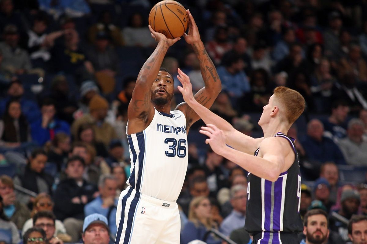 Dec 5, 2024; Memphis, Tennessee, USA; Memphis Grizzlies guard Marcus Smart (36) shoots for three as Sacramento Kings guard Kevin Huerter (9) defends during the first quarter at FedExForum. Mandatory Credit: Petre Thomas-Imagn Images